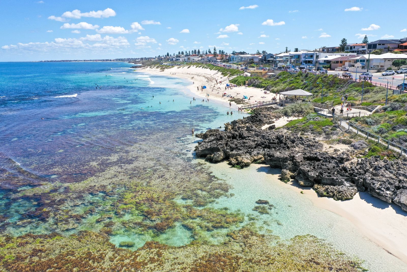 Mettams Pool from the air, looking north: the reef and lagoon, the access ramp and shelter, and houses along West Coast Drive