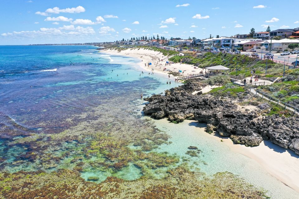 Mettams Pool from the air, looking north: the reef and lagoon, the access ramp and shelter, and houses along West Coast Drive