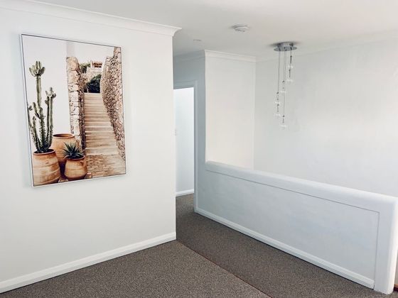 Upstairs landing with a framed print and pendant light