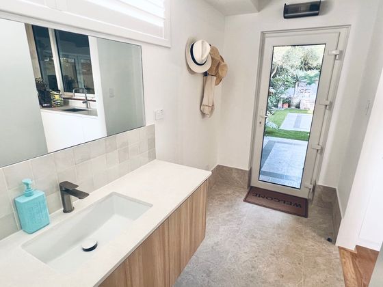 Powder room vanity with a glass door opening to the terrace and garden